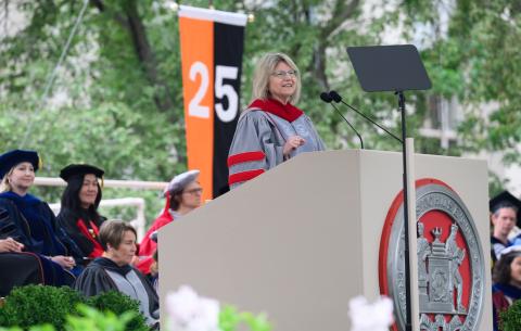 Image of President Sally Kornbluth speaking at the podium during the OneMIT Commencement Ceremony