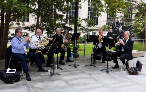 Image of a group of musicians playing music as guests arrive
