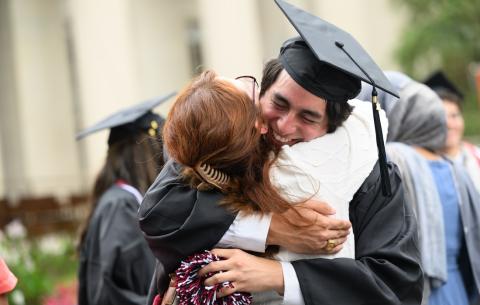 Image of graduate hugging their family member at the Undergraduate Ceremony