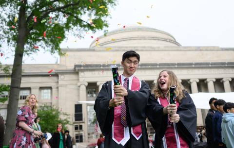 Image of graduates popping confetti canons after the Undergraduate Ceremony