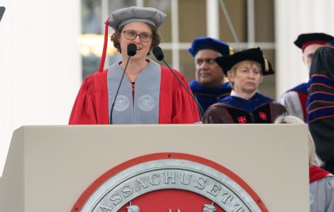 Image of Thea Keith-Lucas speaking at the podium during the OneMIT Commencement Ceremony